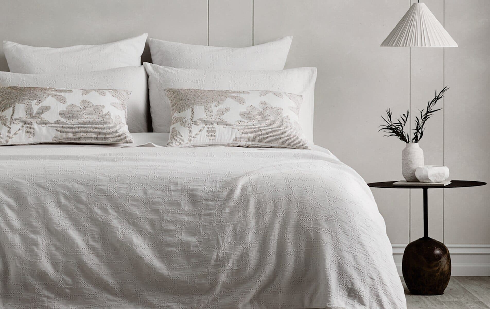 A made bed in soft morning light